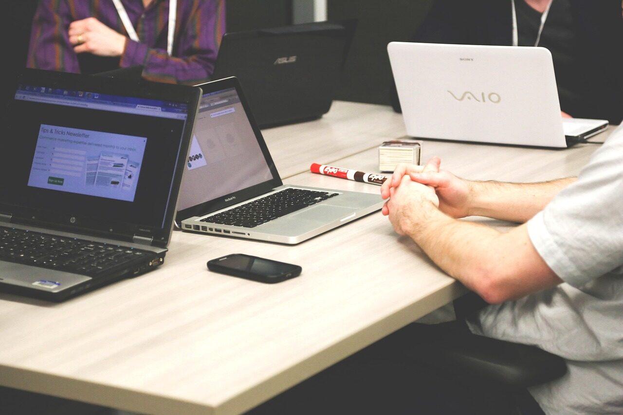 person working on blue and white paper on board